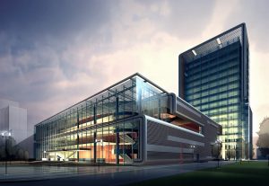 A contemporary glass and steel office park complex with a low-rise and a taller building, set against an overcast sky. The EverGreen design showcases elegant lines and illuminated interiors.